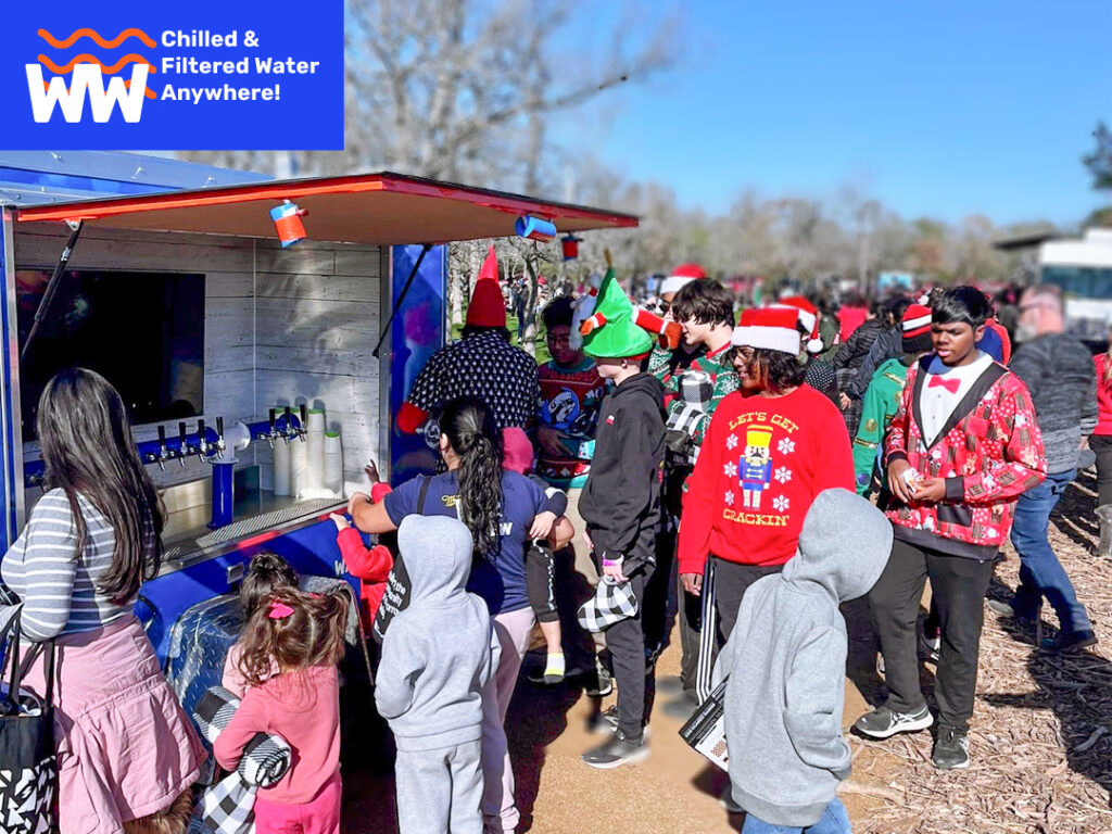 kids in costumes around a wallop water hydration station