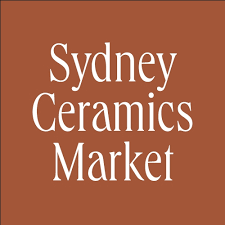 Sydney Ceramics Market logo on brown background.