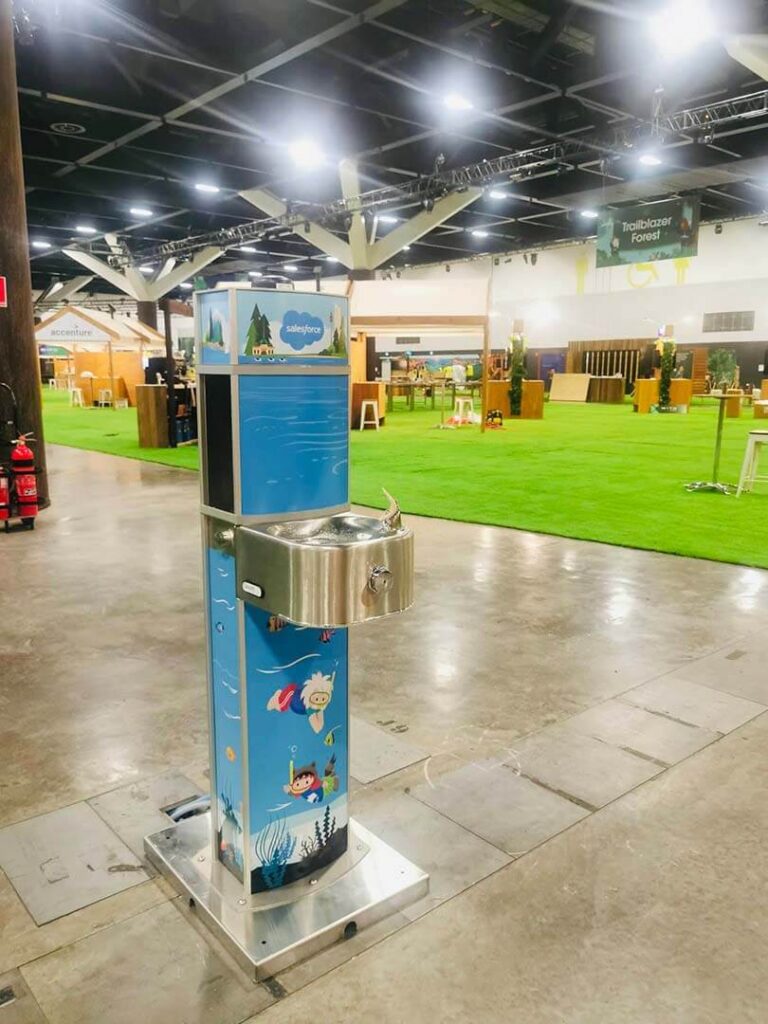 Colorful drinking fountain in large indoor space.