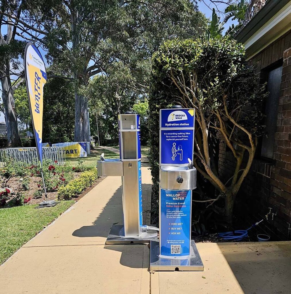 Outdoor hydration station next to a start banner.