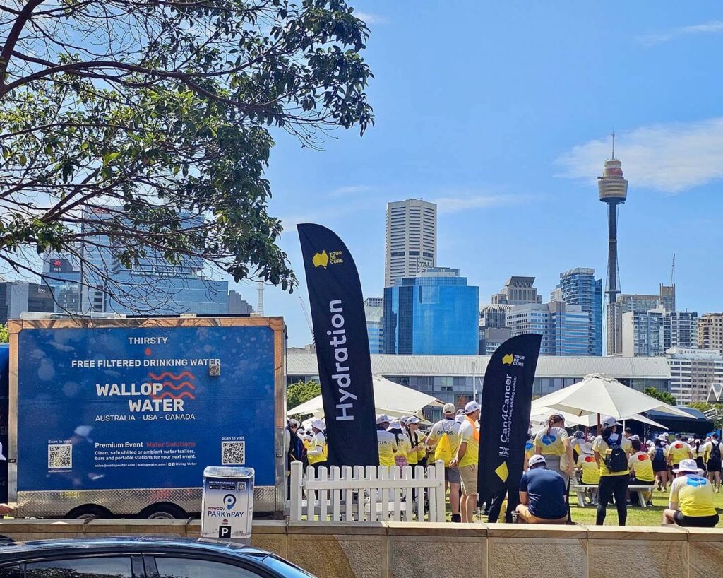 Event with free filtered water booth and city skyline.