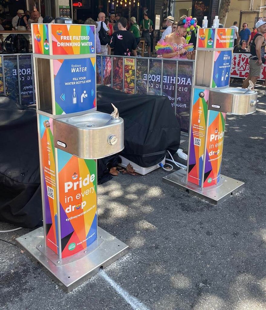 Colorful public water fountains at pride event.