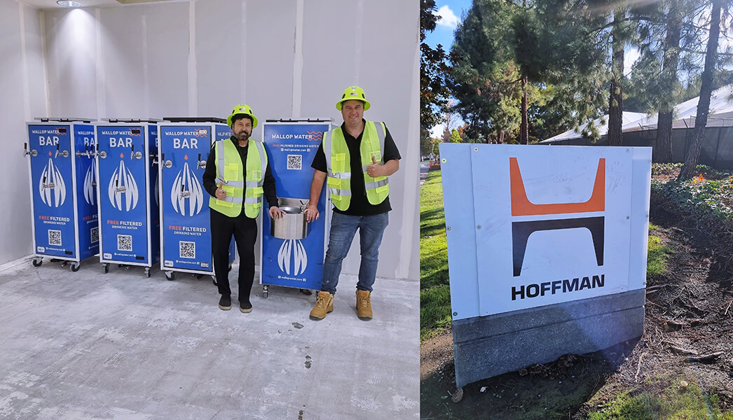 Construction workers beside water station and Hoffman sign.