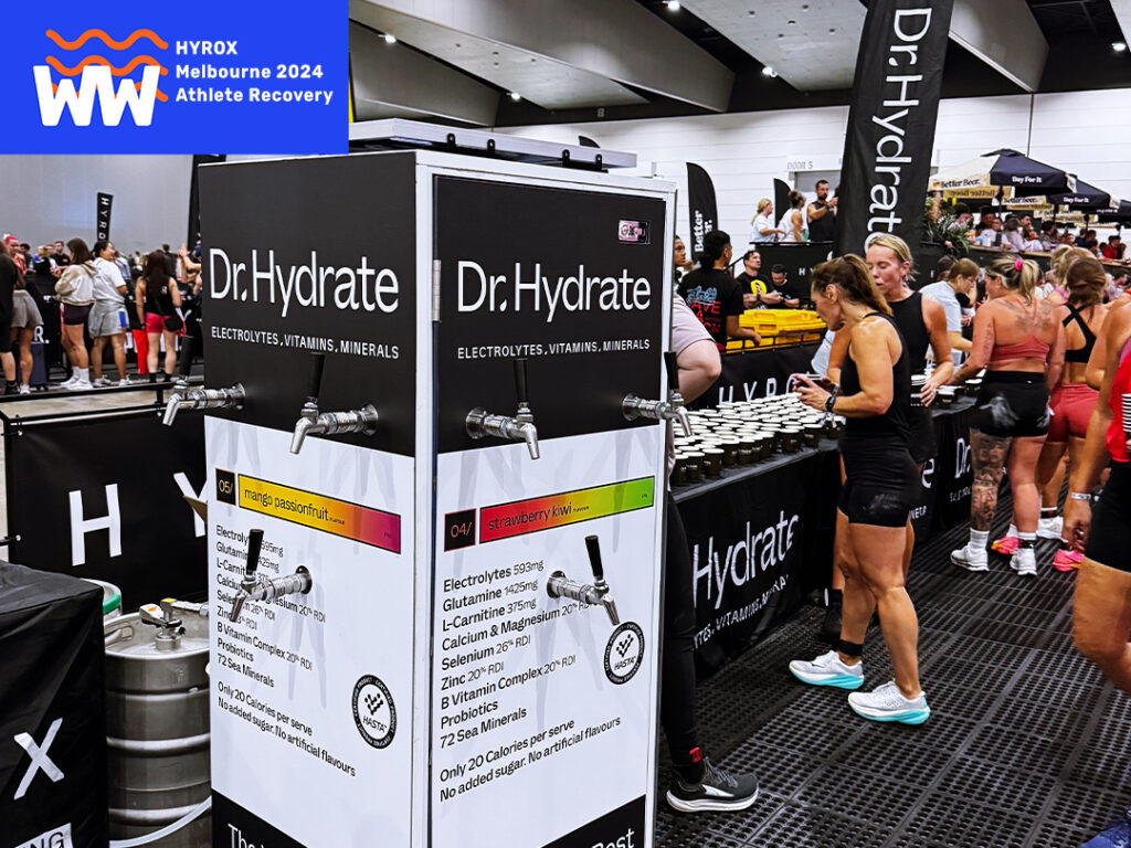 Athletes refueling at Dr. Hydrate's Monster Bar Hydration station, HYROX Melbourne 2024 event.