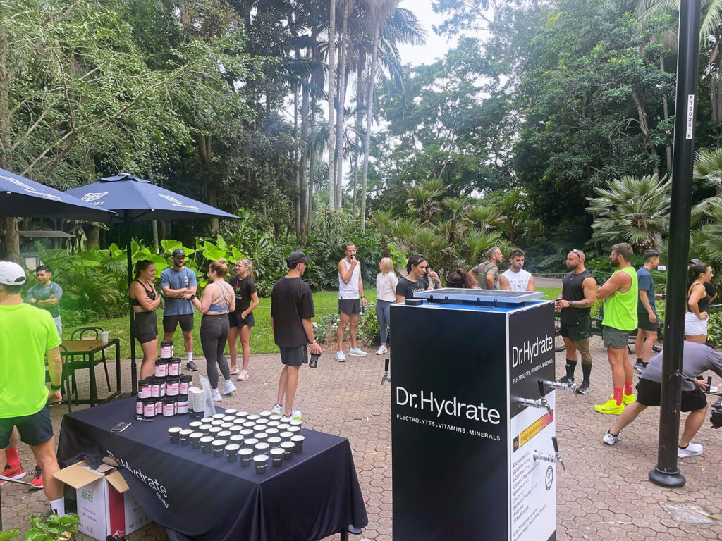 Outdoor event with people and Dr. Hydrate booth.