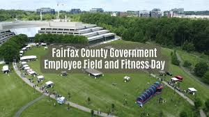 Outdoor event with tents and people, fitness day