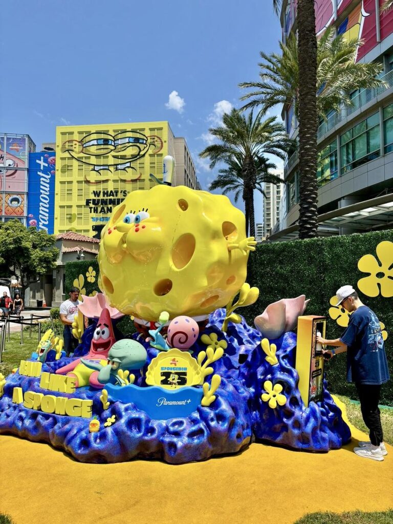 SpongeBob display with characters and a person interacting.