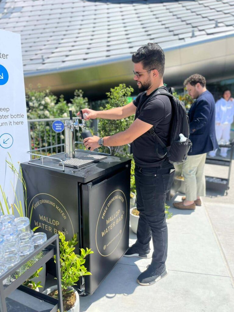 Man filling bottle at outdoor water station