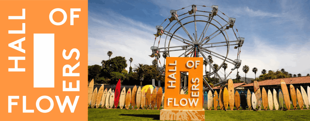 Hall of Flowers sign with surfboards and Ferris wheel.