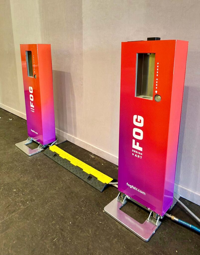 Two red fog dispensers in a room