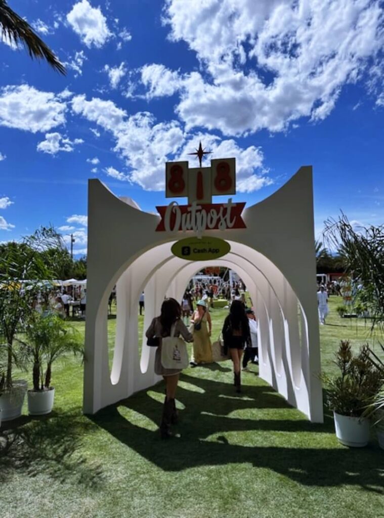 People walking through 818 Outpost festival archway