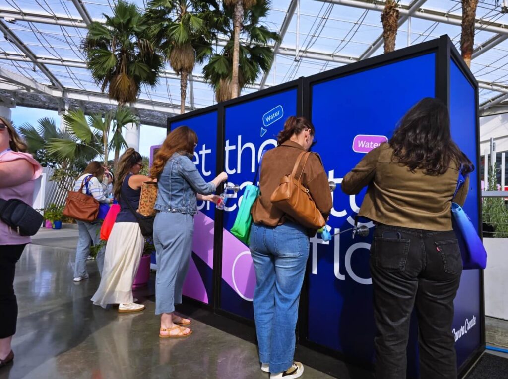People filling water bottles at indoor hydration station