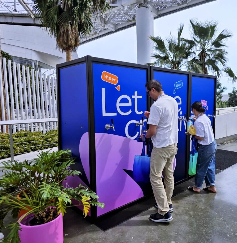 People refilling bottles at public water station