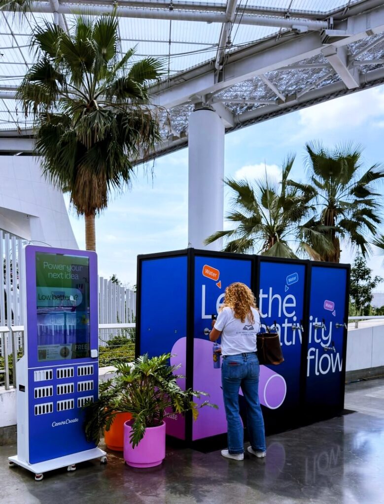 Woman using outdoor water refill station kiosk