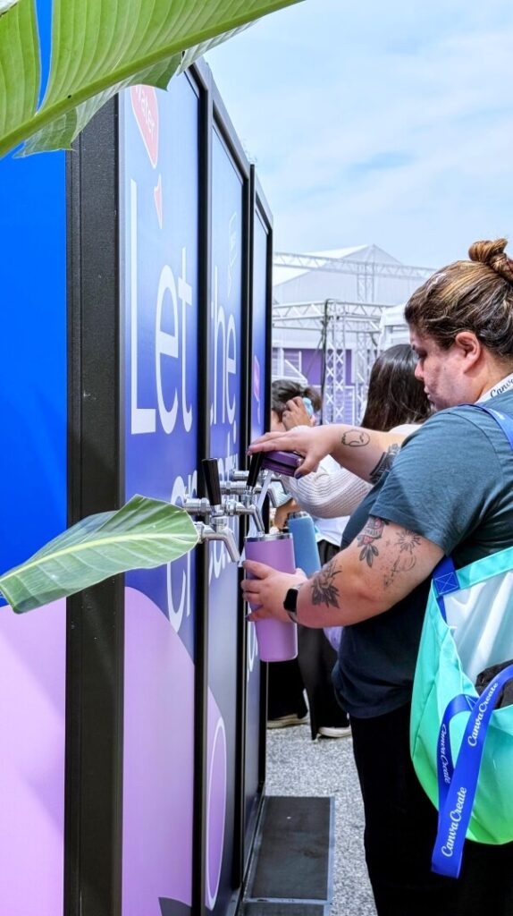Woman filling reusable bottle at water station