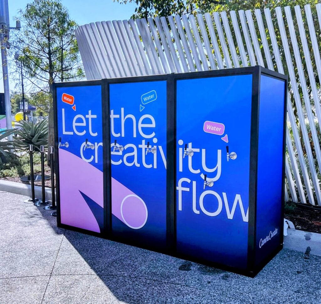 Outdoor branded water tap installation with slogan
