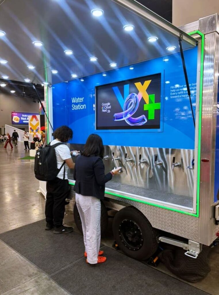 Event attendees filling bottles at branded water station