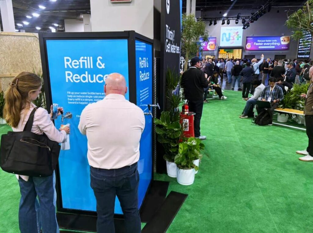 People refilling water bottles at trade show booth