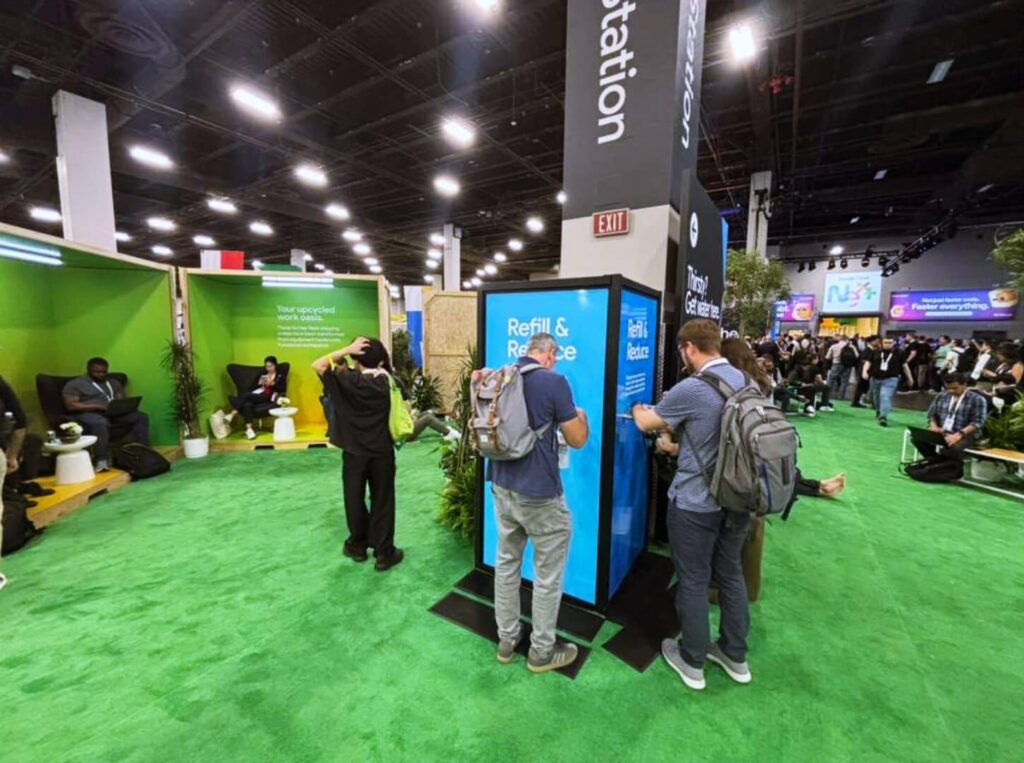Attendees using refill station at busy trade show