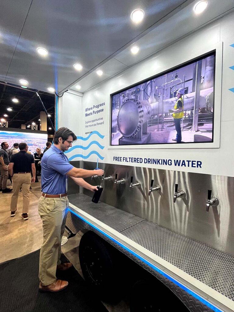 Man filling bottle at trade show water station
