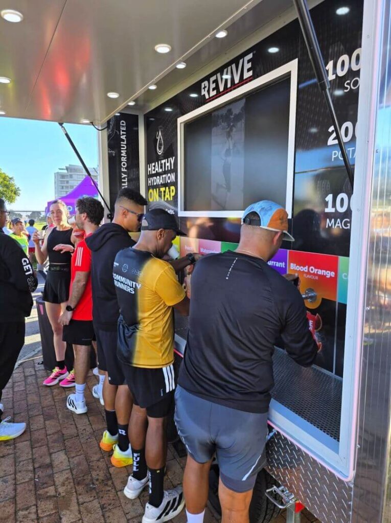 People filling drinks at outdoor hydration station
